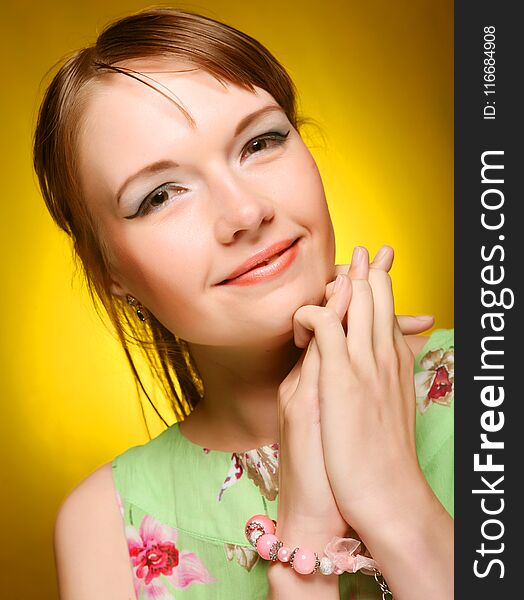 Beautiful young woman face on yellow background. Beautiful young woman face on yellow background