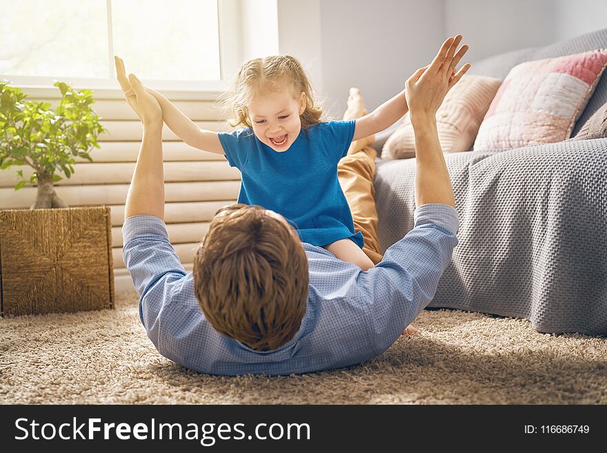 Happy loving family. Daddy and his daughter child girl playing together. Father`s day concept. Happy loving family. Daddy and his daughter child girl playing together. Father`s day concept.