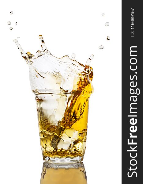 Glass of apple juice with a splash from an apple slice isolated on a white background. Glass of apple juice with a splash from an apple slice isolated on a white background