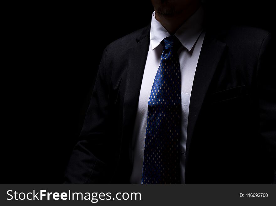 Close upsmart businessman with black suit in dark concept. Close upsmart businessman with black suit in dark concept