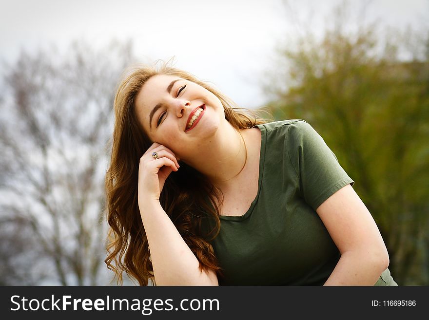 Woman in Green Shirt Smiling