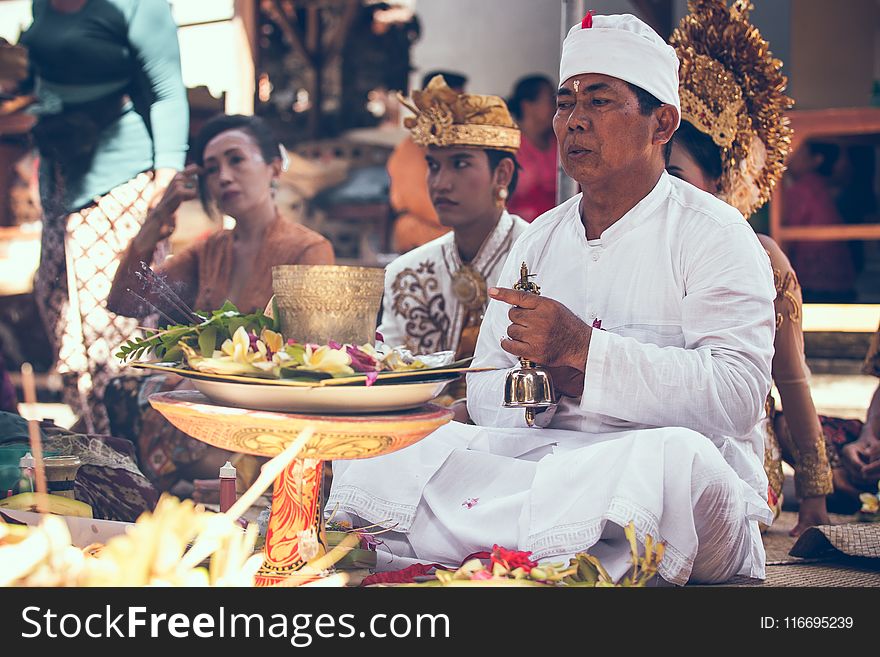 Man Sitting in Front of Woman Near Table Performing Ritual Ceremony