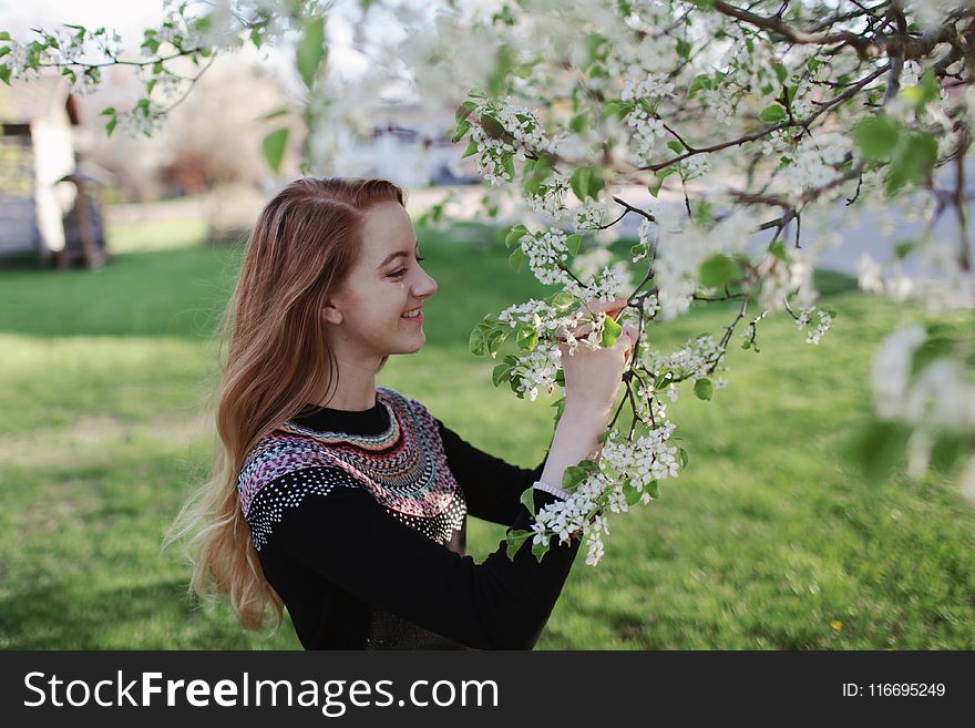 Woman In Black Sweater Holding Flowers