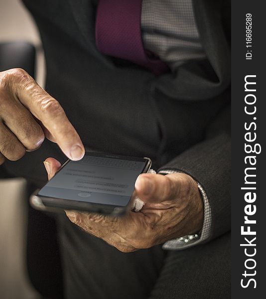 Person Holding Black Smartphone