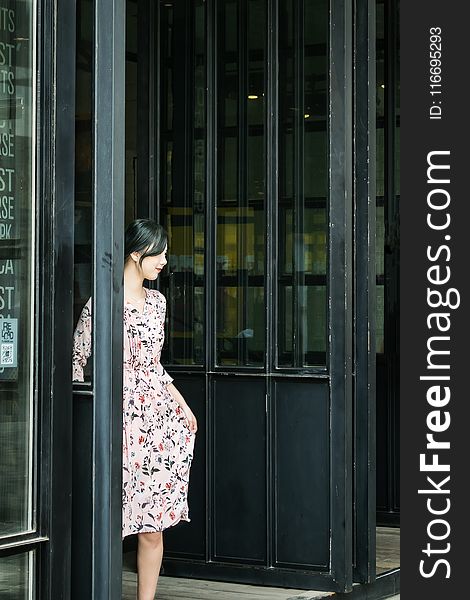 Black Haired Woman in Pink and Black Floral Dress