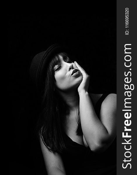 Grayscale Photography Of Woman In Tank Top Wearing Hat