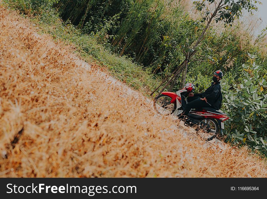 Man On White And Red Underbone Motorcycle