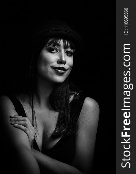 Greyscale Photo of Woman Wearing Tank Top and Hat