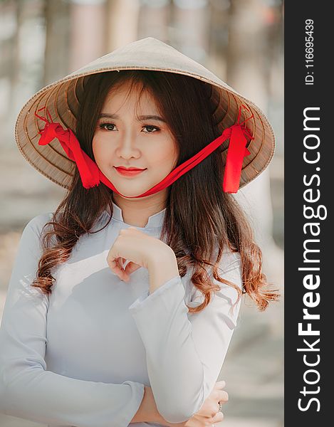 Photography of a Woman Wearing Asian conical hat