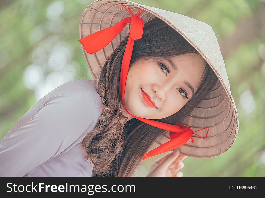 Close-Up Photography of a Woman Wearing Conical Hat