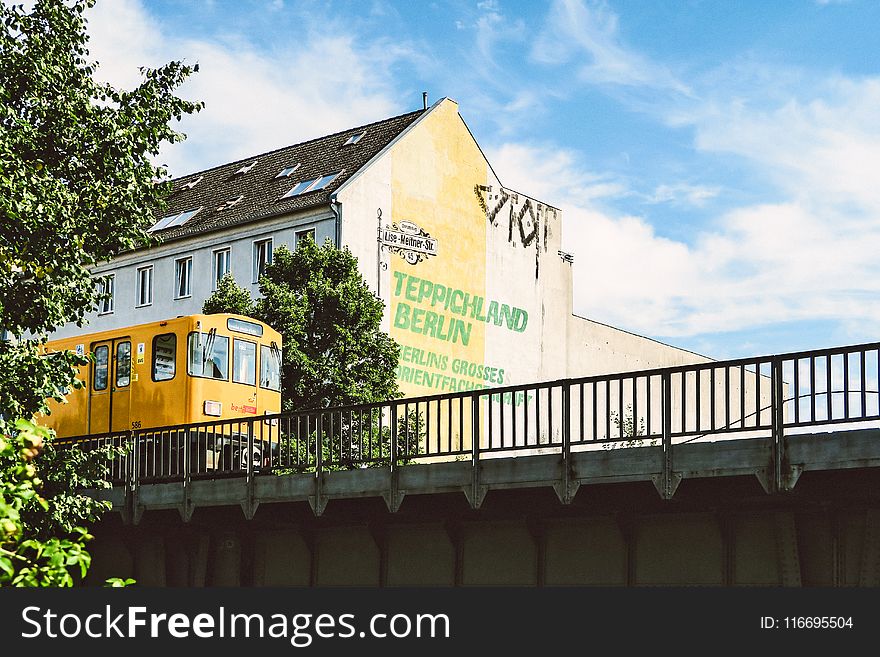 Yellow Train Beside Teppichland Berun Building