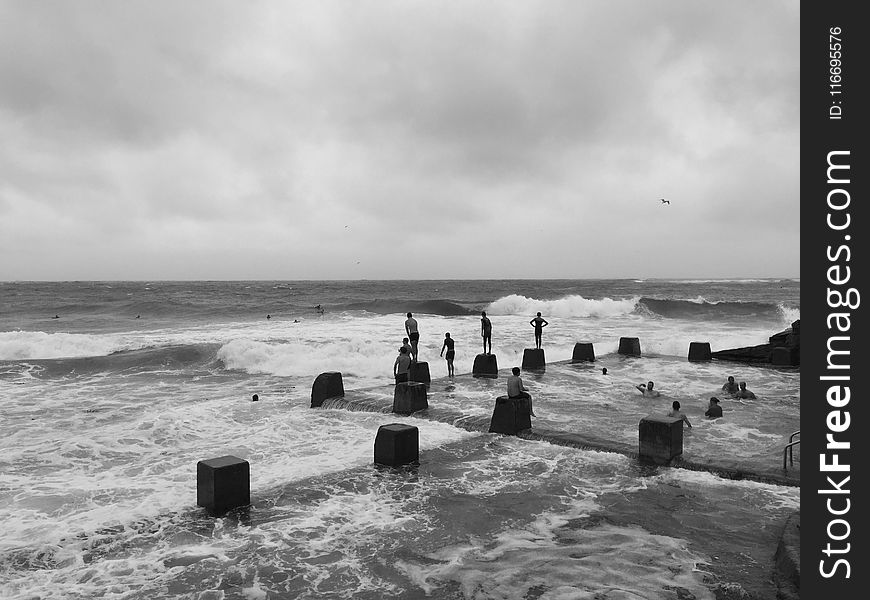 Grayscale Photo of People in Beach