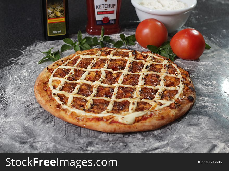 Baked Pizza Beside Two Red Tomatoes