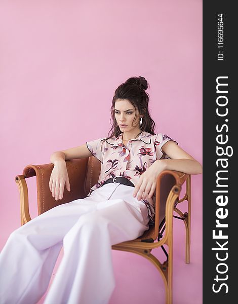 Photography Of A Woman Sitting On Chair