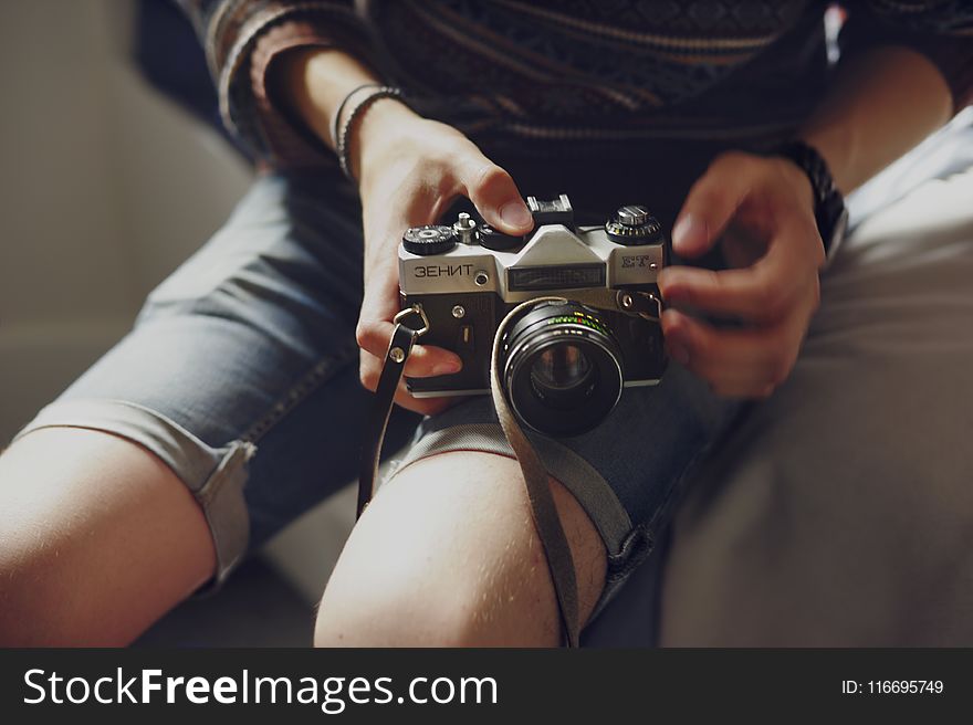 Person Holding Black and Gray Dslr Camera