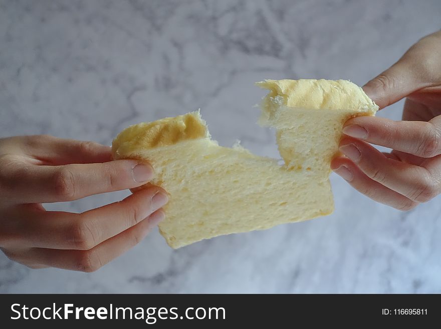Person Holding Slice of Loaf Bread