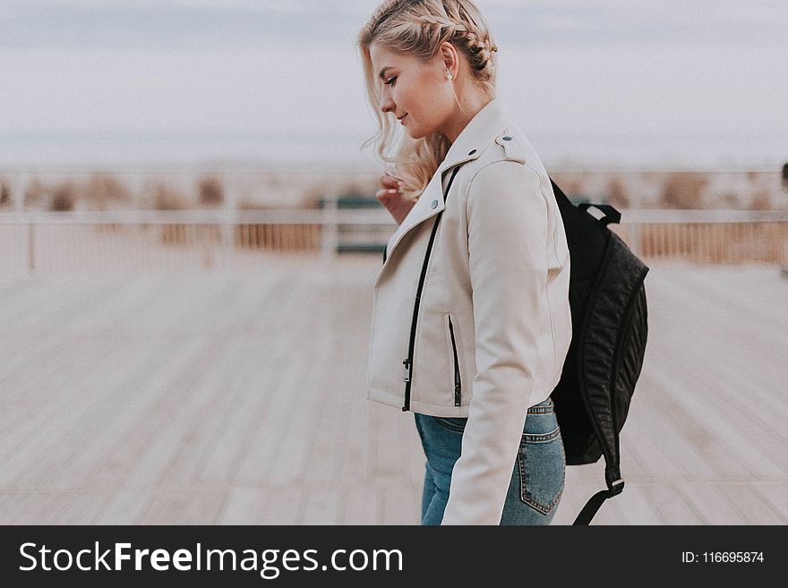Woman in Black Zip-up Jacket With Black Backpack