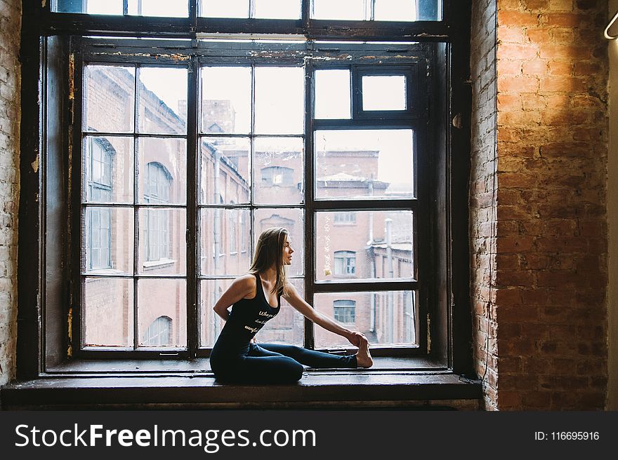 Woman Stretching Beside Window