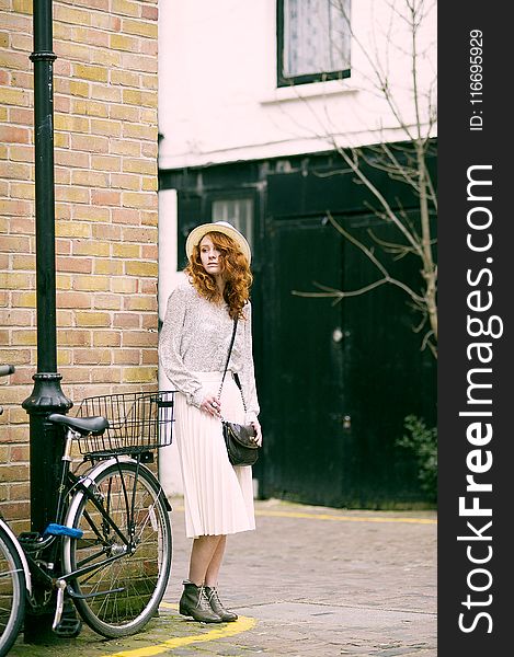 Woman Wearing White Long-sleeved Dress Near Bicycle