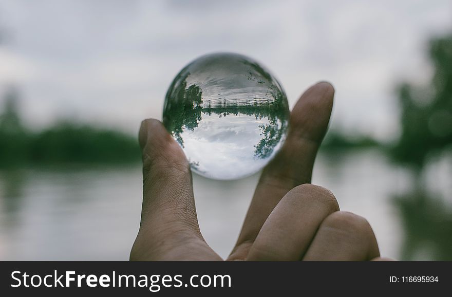 Close-Up Photography Of Person Holding Crystal Ball