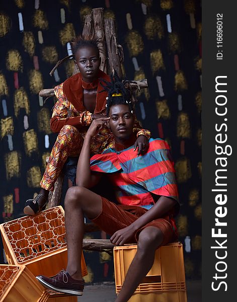 Couple Sitting and Standing on Crates for Photo