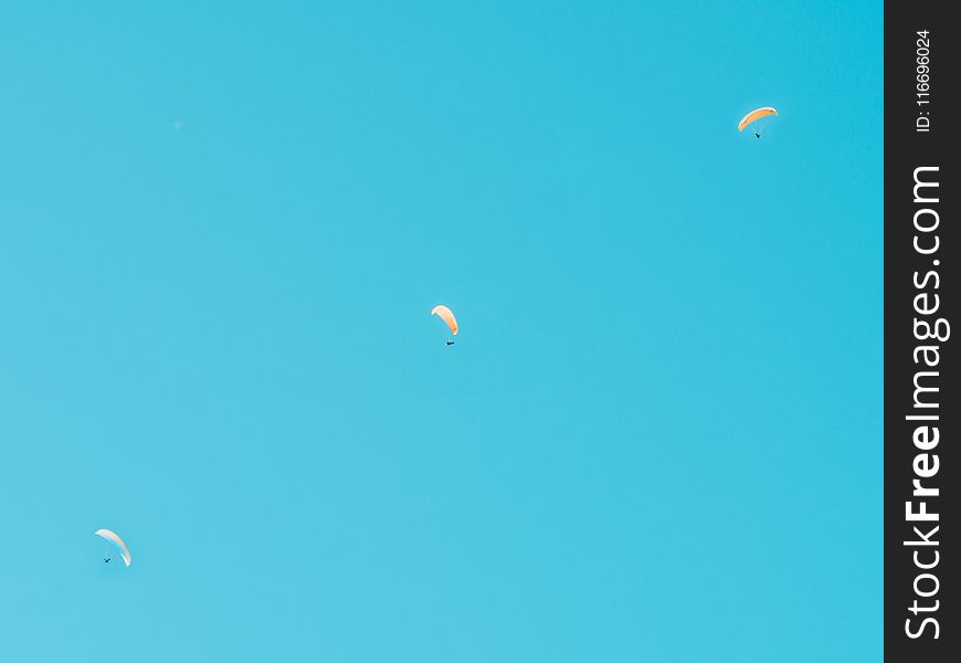 Photo of Three Person in Parachutes