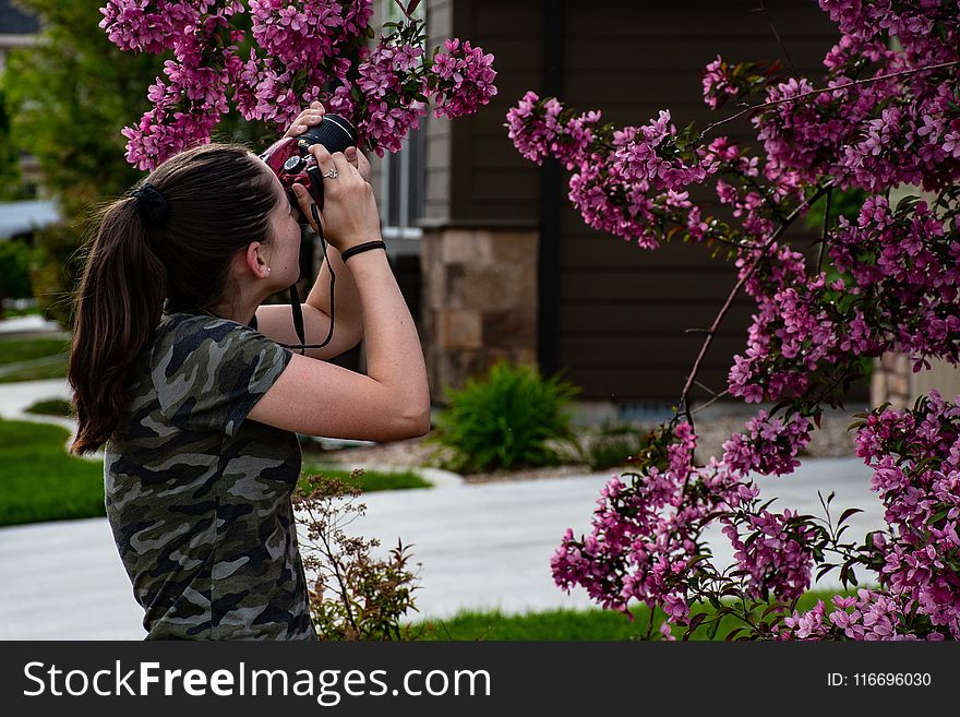 Woman in Gray Camouflage Shirt Holding Camera
