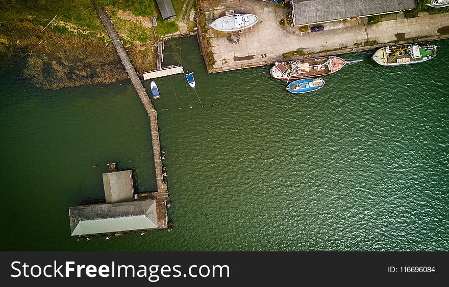 Bird&#x27;s Eye View of Boat Near Dock on Calm Body of Water