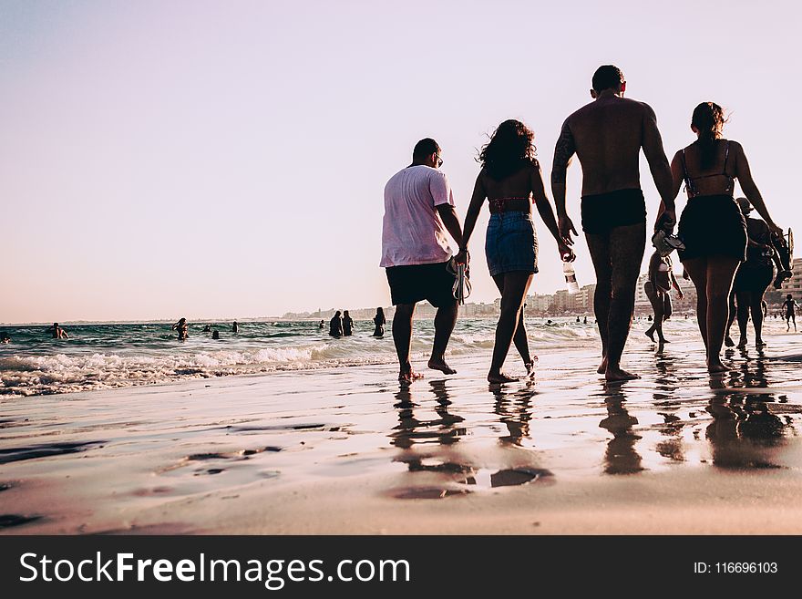 People Walking On Seashore