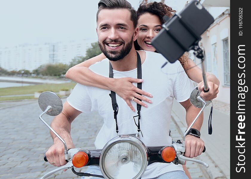 Happy young couple having summer trip on a scooter. Happy young couple having summer trip on a scooter