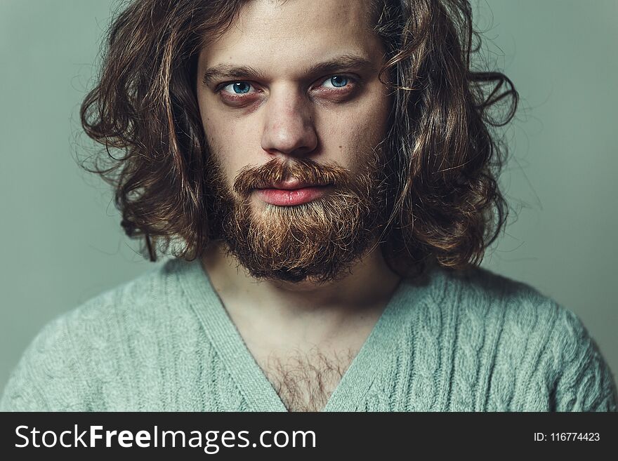 Handsome brutal man with a beard and long hair. Creative headshot artist portrait. Handsome brutal man with a beard and long hair. Creative headshot artist portrait