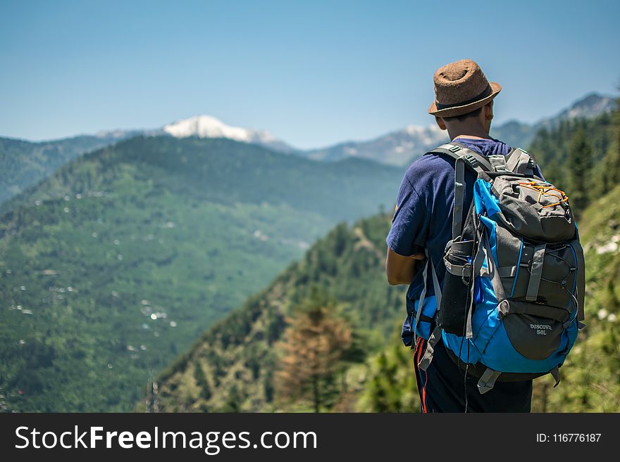 Selective Focus Photography of Man Carrying Hiking Pack