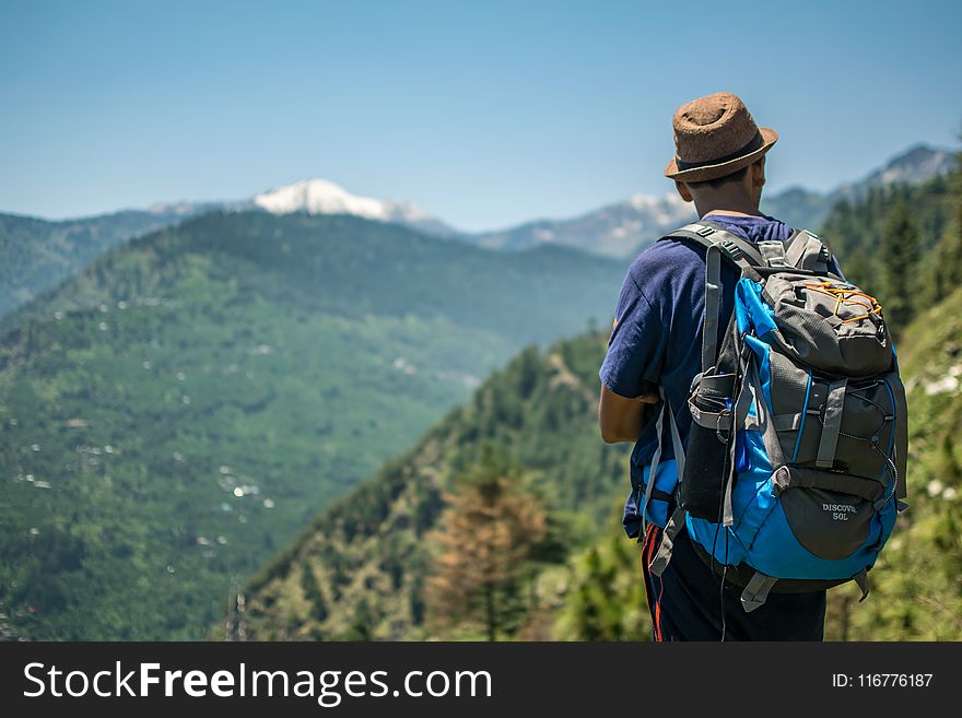 Selective Focus Photography Of Man Carrying Hiking Pack