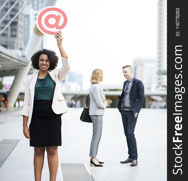 Woman Holding @ Sign