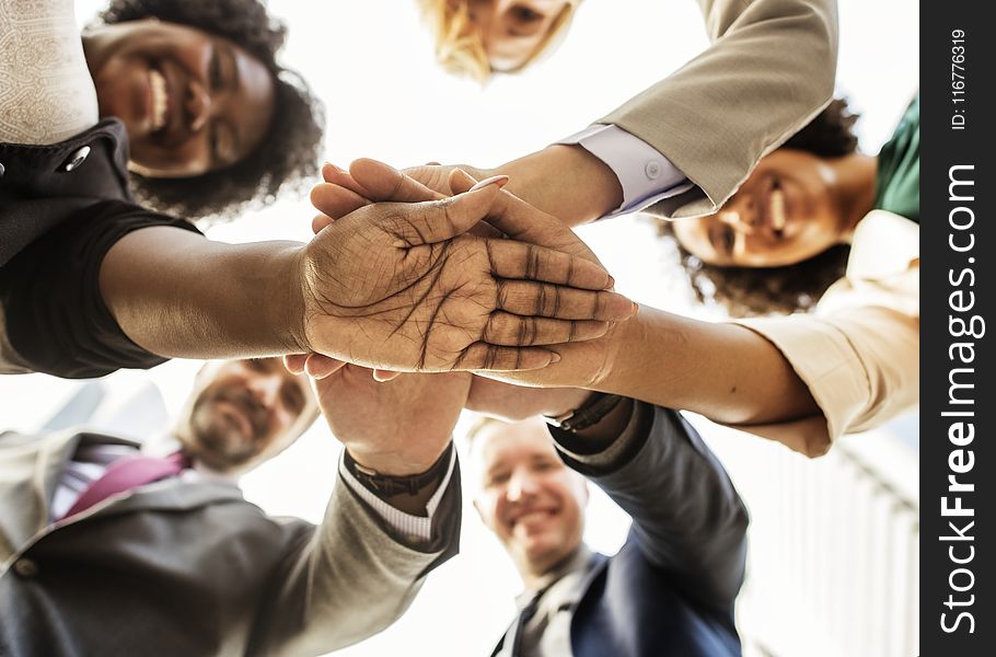 Photography Of People Stacking Hands Together