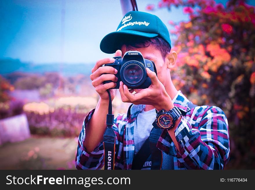 Shallow Focus Photography of a Man Holding Camera