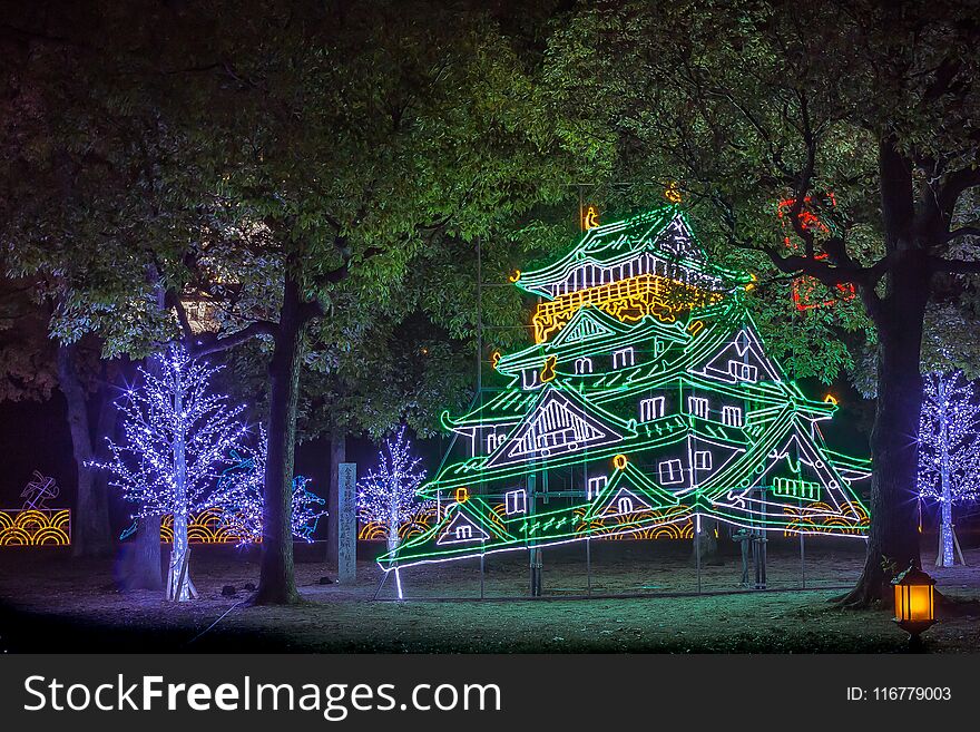 Scenic view of illuminated Japanese style pagoda and trees at night. Scenic view of illuminated Japanese style pagoda and trees at night.