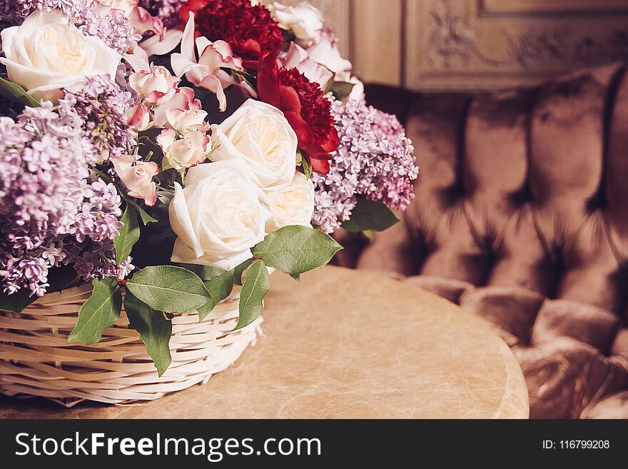Bouquet of lilacs and red peonies on marble table