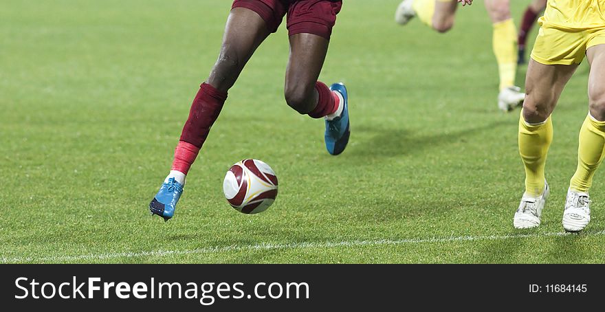 Soccer players running after the ball