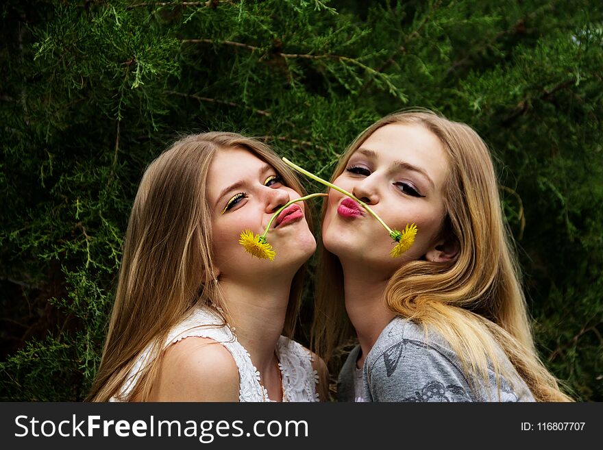 Two cute and beautiful teen girls show grimaces on their faces. Two cute and beautiful teen girls show grimaces on their faces.