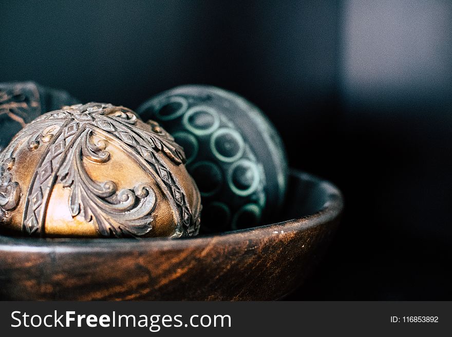 Brown And Two Black Ball In Bowl Photography