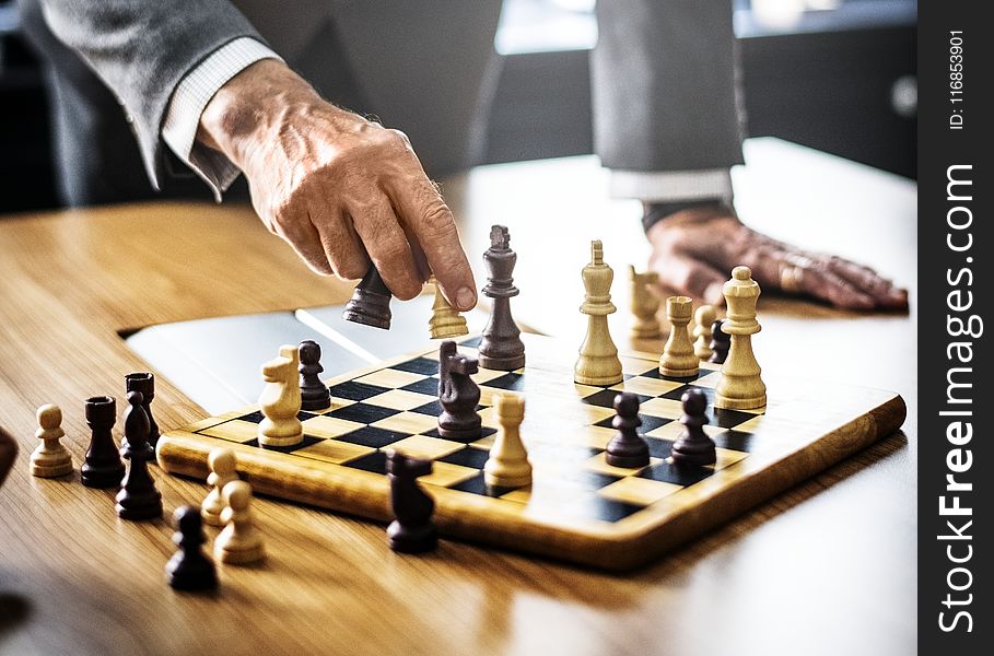 Man in Gray Suit Playing Chess