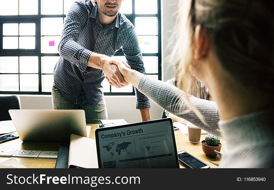 Man Shaking Hands With Woman
