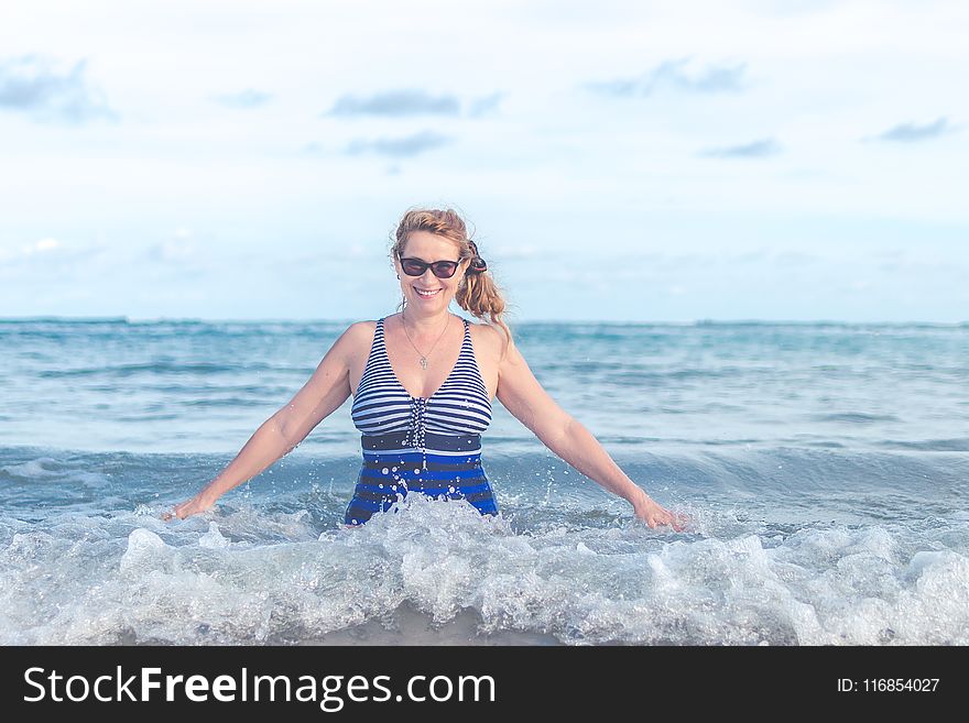Woman Wearing Blue and Grey Swimsuit on Ocean