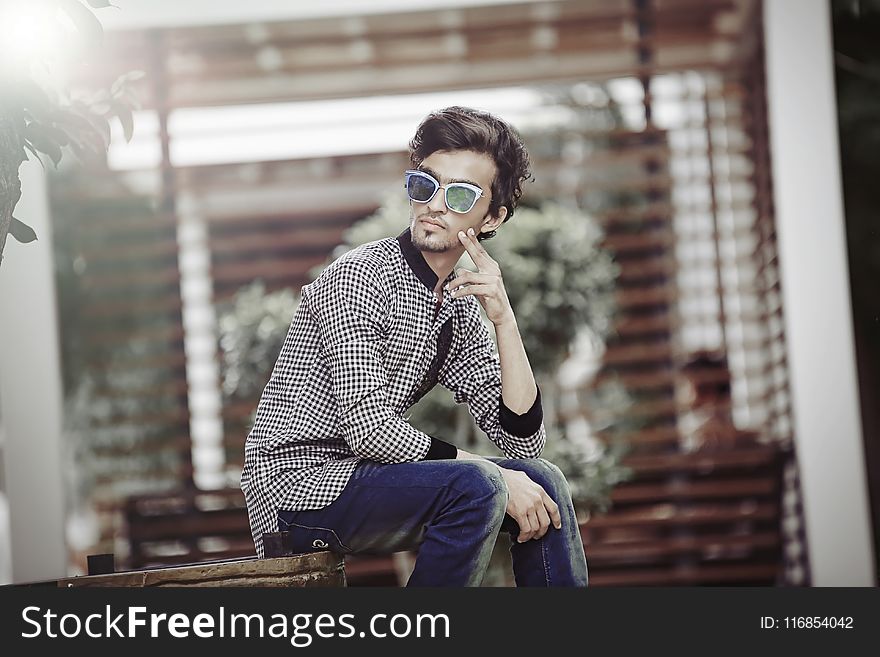 Man Sitting on Brown Wooden Chair