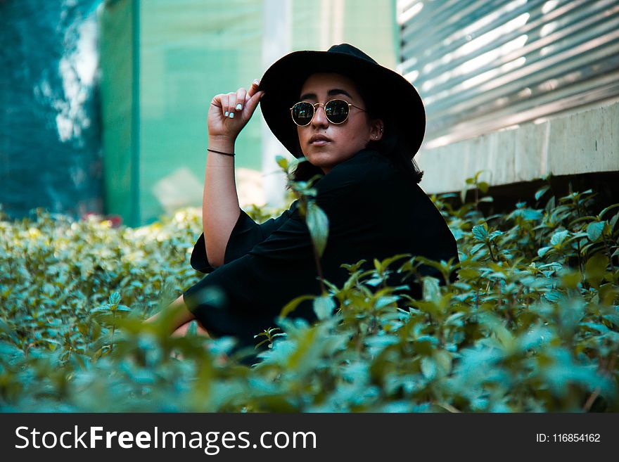 Person In Black Top Wearing Black Bucket Cap