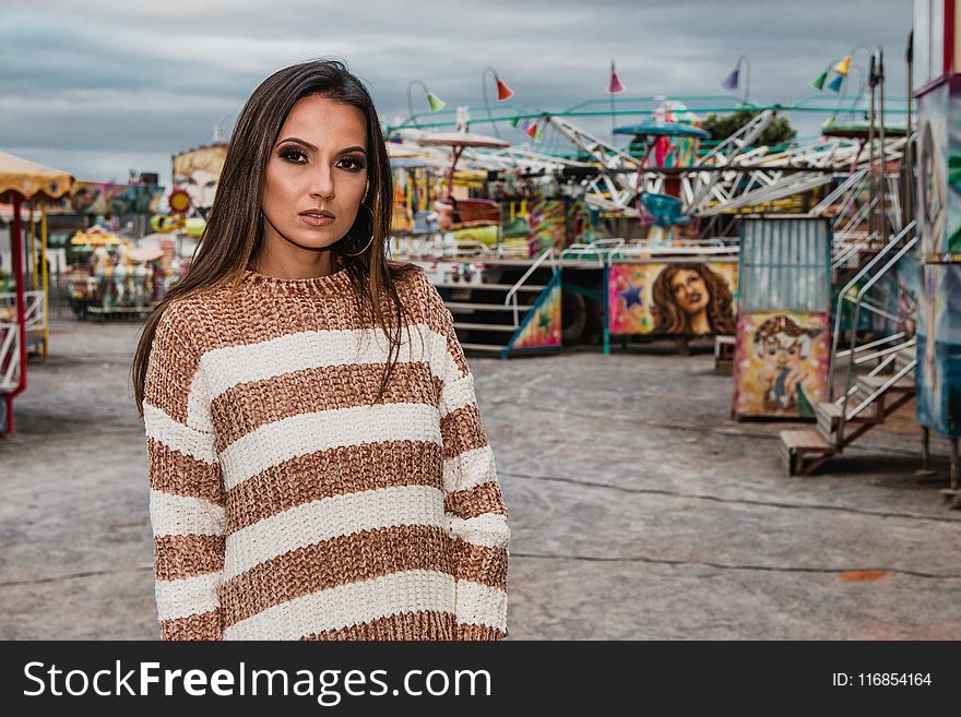 Woman In White And Brown Striped Sweater