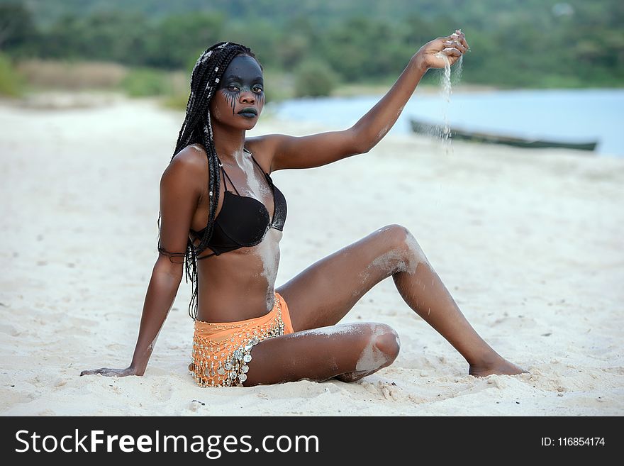 Fashion Photography of Woman Sitting on White Sand White Pouring Sand on Her Hand