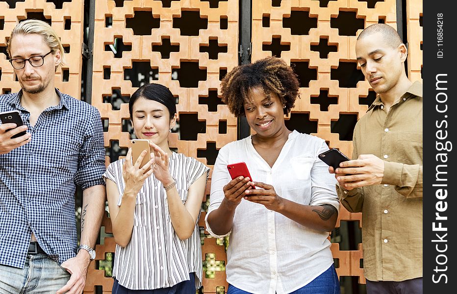 Four People Holding Mobile Phones