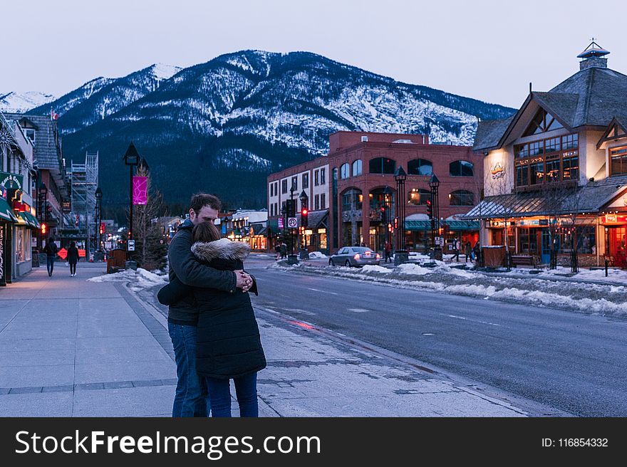 Man Hugging Woman on Street